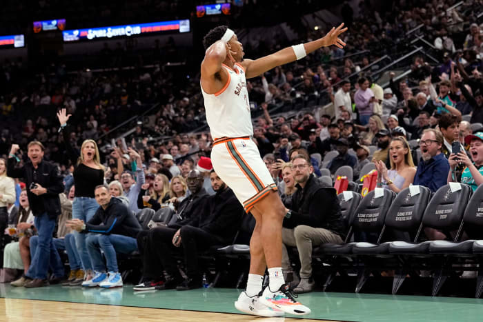 Dec 15, 2023; San Antonio, Texas, USA; San Antonio Spurs forward Keldon Johnson (3) reacts after scoring a three pointer during the first half against the Los Angeles Lakers at Frost Bank Center.